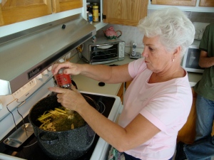 Aunt Joan puts the finishing touches on the broth